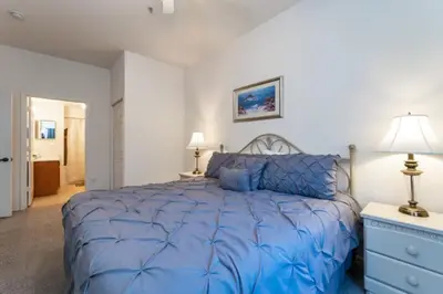 a bedroom with a blue bed with a blue comforter at Townhome Near Disney Mid Term rentals Welcome in Kissimmee