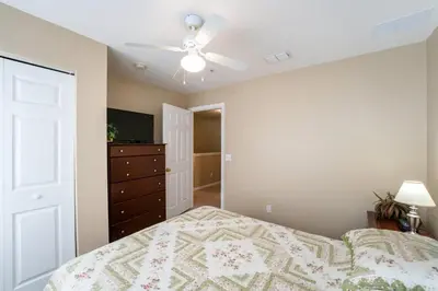 a bedroom with a bed and a ceiling fan at Resort Bliss Near Disney Longer Stays Welcome in Kissimmee