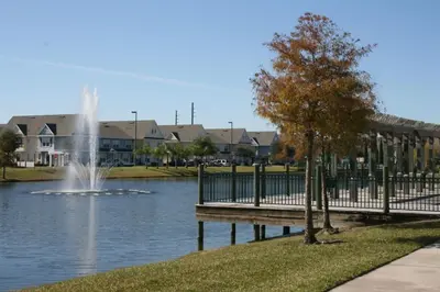 a park with a fountain in the middle of a pond at Resort Bliss Near Disney Longer Stays Welcome in Kissimmee