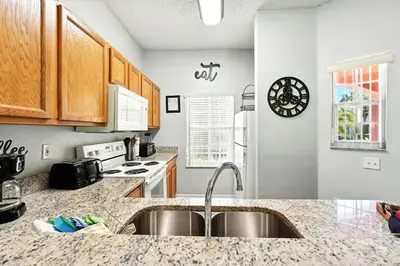 a kitchen with a sink and a counter top at Family Getaway Near Clubhouse and Community Pool 5 miles from Disney in Kissimmee