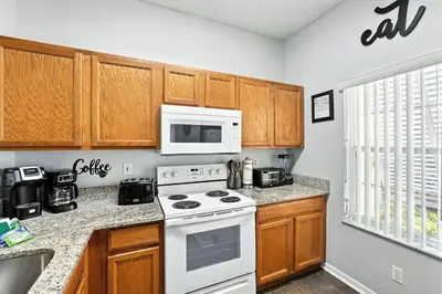 a kitchen with a white stove and a microwave at Family Getaway Near Clubhouse and Community Pool 5 miles from Disney in Kissimmee