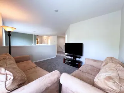 a living room with two couches and a flat screen tv at Disney Getaway Villa with Private Pool Hot Tub. Book Now VP140 in Kissimmee
