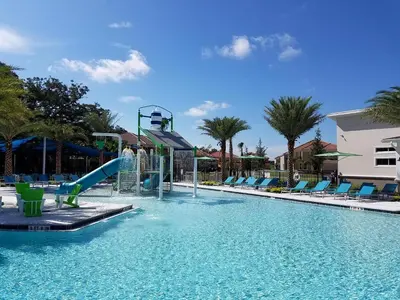 a swimming pool with a water slide in a resort at Disney Getaway Villa with Private Pool Hot Tub. Book Now VP140 in Kissimmee