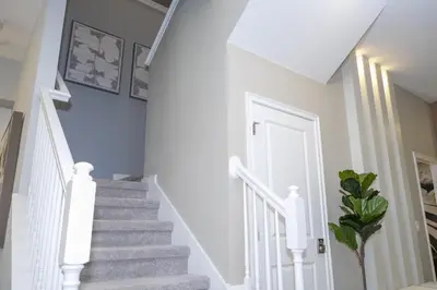 a white staircase in a home with a white stair case at Disney Private Pool Game Room Themed Bedrooms. Book Now PG25 in Orlando