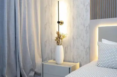 a white vase on a nightstand next to a bed at Disney Private Pool Game Room Themed Bedrooms. Book Now PG25 in Orlando