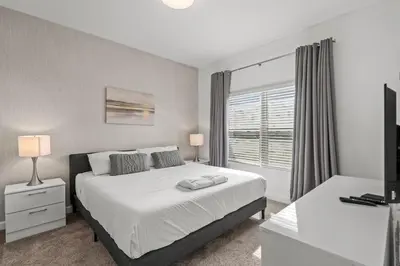 a bedroom with a white bed and a window at Disney Getaway Private Pool Themed Bedrooms. Book Now SLR1243 in Kissimmee