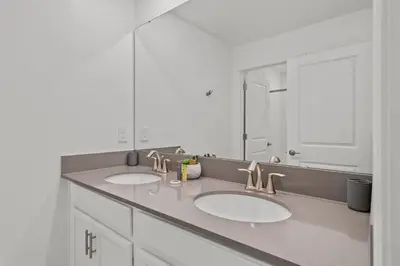 a bathroom with two sinks and a large mirror at Disney Getaway Private Pool Themed Bedrooms. Book Now SLR1243 in Kissimmee