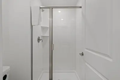 a shower with a glass door in a bathroom at Disney Getaway Private Pool Themed Bedrooms. Book Now SLR1243 in Kissimmee