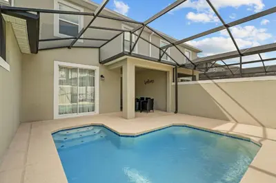 a swimming pool in the backyard of a house at Disney Getaway Private Pool Themed Bedrooms. Book Now SLR1243 in Kissimmee