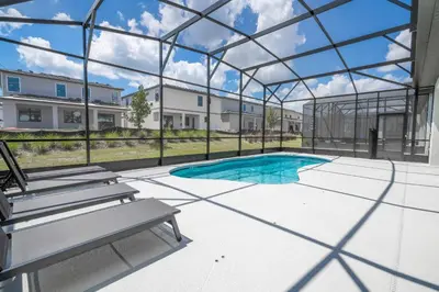 a swimming pool in a glass house with a bench at Disney Private Pool Game Room Themed Bedrooms. Book Now PG20 in Orlando