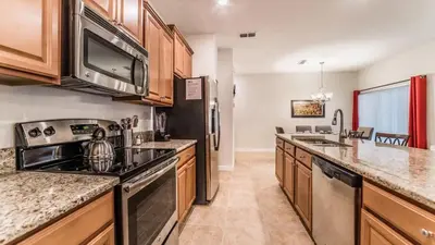 a kitchen with a sink and a stove at Disney Getaway Townhouse with Private Pool. Book Now SLR484 in Kissimmee