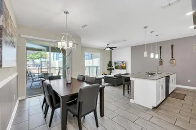 a kitchen and living room with a table and chairs at Disney Getaway Private Pool Themed Bedrooms. Book Now SLR1162 in Kissimmee