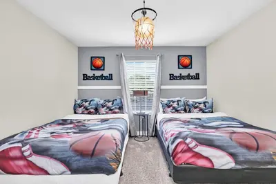 a bedroom with two beds and a chandelier at Disney Getaway Private Pool Themed Bedrooms. Book Now SLR1162 in Kissimmee
