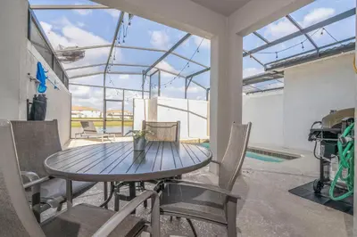 a dining room with a table and chairs and a pool at Disney Getaway Private Pool Themed Bedrooms. Book Now SLR410 in Kissimmee