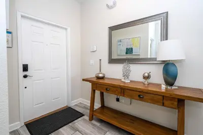 a room with a table with a mirror and a door at Disney Getaway Private Pool Themed Bedrooms. Book Now SLR410 in Kissimmee