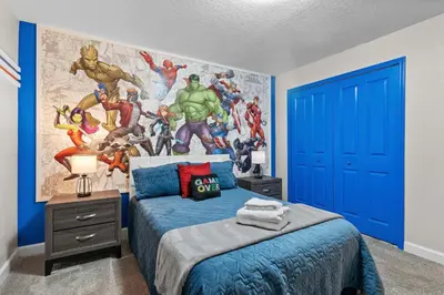 a bedroom with a superheroes mural on the wall at Disney Getaway Private Pool Themed Bedrooms. Book Now SLR411 in Kissimmee