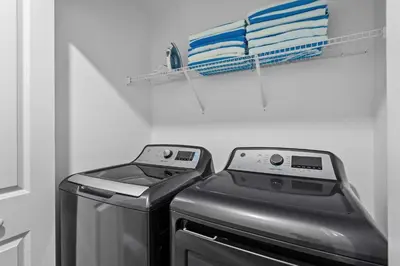 a washing machine and a washer in a bathroom at Disney Getaway Private Pool Themed Bedrooms. Book Now SLR411 in Kissimmee