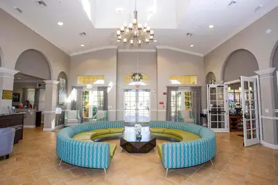 a lobby with two blue couches and a table at Disney Getaway Townhouse with Private Pool. Book Now VC304 in Orlando