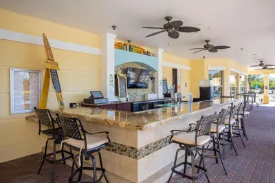 a bar in a restaurant with chairs around it at Disney Getaway Townhouse with Private Pool. Book Now VC304 in Orlando