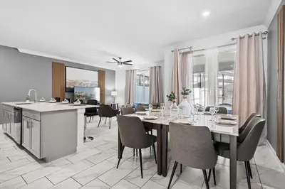 a kitchen and dining room with a table and chairs at Disney Getaway Private Pool Themed Bedrooms. Book Now SLR481 in Kissimmee