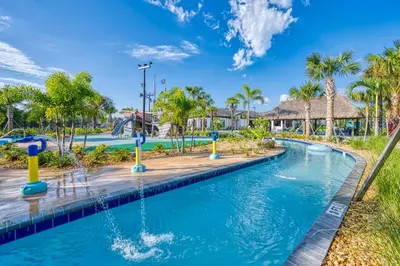 a pool at a resort with palm trees at Disney Getaway Private Pool Themed Bedrooms. Book Now SLR481 in Kissimmee