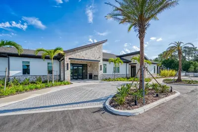 a house with a palm tree in front of it at Disney Getaway Private Pool Themed Bedrooms. Book Now SLR481 in Kissimmee