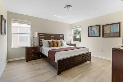 a bedroom with a large bed and a window at Disney Getaway Luxury Villa with Private Pool. Book Now BV75 in Kissimmee