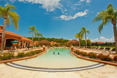 a swimming pool at a resort with palm trees at Disney Getaway Luxury Villa with Private Pool. Book Now BV75 in Kissimmee