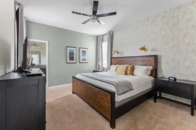 a bedroom with a bed and a ceiling fan at Disney Private Pool Hot Tub Game Room Themed Bedrooms. Book Now SLR497 in Kissimmee