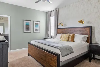 a bedroom with a large bed and a window at Disney Private Pool Hot Tub Game Room Themed Bedrooms. Book Now SLR497 in Kissimmee