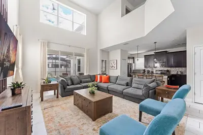 a living room with a couch and a table at Disney Private Pool Hot Tub Game Room Themed Bedrooms. Book Now SLR497 in Kissimmee