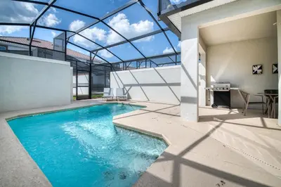 an indoor swimming pool with a glass ceiling at Disney Getaway Private Pool Themed Bedrooms. Book Now SLR377 in Kissimmee