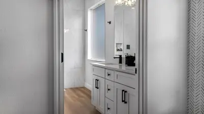 a white bathroom with a sink and a mirror at Disney Private Pool Hot Tub Game Room Themed Bedrooms. Book Now EIR179 in Kissimmee