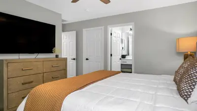 a bedroom with a bed and a flat screen tv at Disney Private Pool Hot Tub Game Room Themed Bedrooms. Book Now EIR179 in Kissimmee