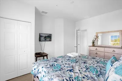 a bedroom with a bed and a dresser and a window at Disney Getaway Townhouse with Private Pool. Book Now WLV82 in Kissimmee