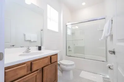 a bathroom with a toilet and a sink and a shower at Disney Getaway Private Pool Themed Bedrooms. Book Now BV241 in Kissimmee