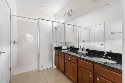 a bathroom with a shower and a sink and a mirror at Disney Getaway Private Pool Game Room. Book Now BV77 in Kissimmee
