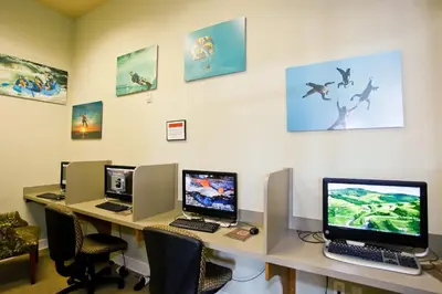 an office with three computers on a desk with chairs at Disney Getaway Private Pool Game Room. Book Now BV77 in Kissimmee