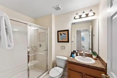 a bathroom with a shower and a toilet and a sink at Disney Private Pool Hot Tub Themed Bedrooms. Book Now BV76 in Kissimmee
