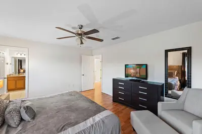a bedroom with a bed and a couch and a mirror at Disney Private Pool Hot Tub Themed Bedrooms. Book Now BV76 in Kissimmee