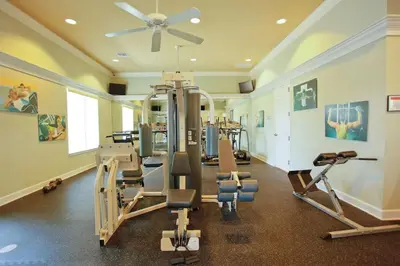 a gym with several tread machines and a ceiling fan at Disney Private Pool Hot Tub Themed Bedrooms. Book Now BV76 in Kissimmee