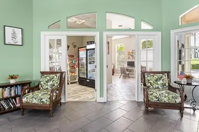 a living room with two chairs and a refrigerator at Disney Getaway Private Pool Themed Bedrooms. Book Now EIR67 in Kissimmee