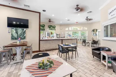 a restaurant with tables and chairs and a bar at Disney Getaway Private Pool Themed Bedrooms. Book Now EIR67 in Kissimmee