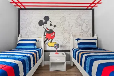 a bedroom with two beds and a mickey mouse mural at Disney Getaway Private Pool Themed Bedrooms. Book Now EIR67 in Kissimmee
