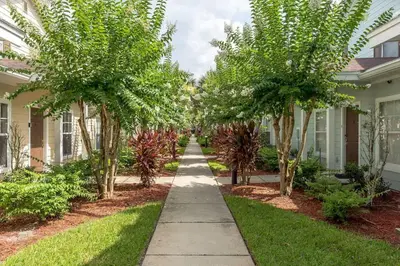 a sidewalk in front of a house with trees at Disney Getaway Private Pool Themed Bedrooms. Book Now LV8 in Kissimmee