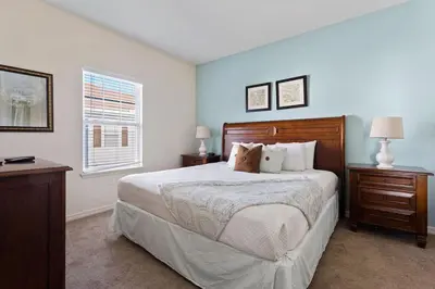 a bedroom with a bed and a desk and a window at Disney Getaway Private Pool Themed Bedrooms. Book Now LV7 in Kissimmee