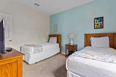 a bedroom with two beds and a flat screen tv at Disney Getaway Private Pool Themed Bedrooms. Book Now LV7 in Kissimmee