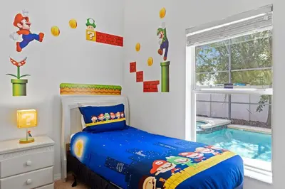 a bedroom with a bed and a swimming pool at Disney Getaway Luxury Villa with Private Pool Game Room. Book Now VP48 in Kissimmee