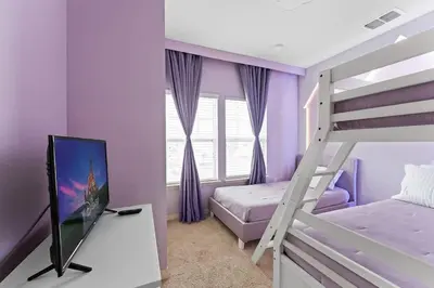 a bedroom with purple walls and a bunk bed at Disney Getaway Private Pool Themed Bedrooms. Book Now WLV83 in Kissimmee