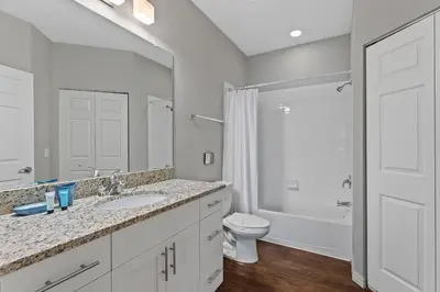 a white bathroom with a toilet and a sink at Disney Getaway Private Pool Themed Bedrooms. Book Now WLV83 in Kissimmee